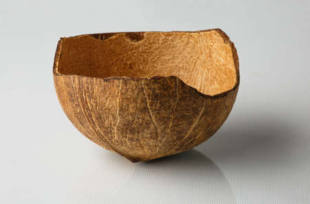 Coconut shell isolated on white background. The coconut flakes are removed from the inside of the coconut shell.の写真素材