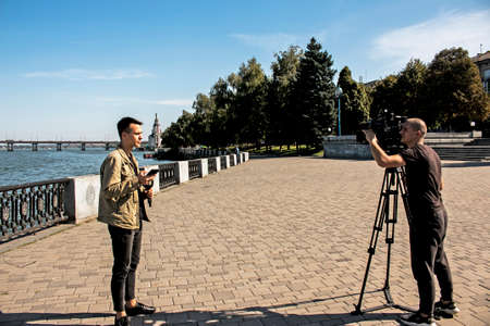 Dnepropetrovsk, Ukraine - 09.17.2021: Local TV journalists are filming an environmental issue. A new island was formed on the Dnieper River.のeditorial素材
