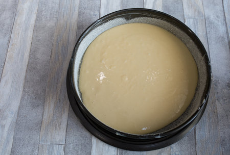 Step by step the process of making sour cream pie dough. Ready raw dough in a prepared baking dish....