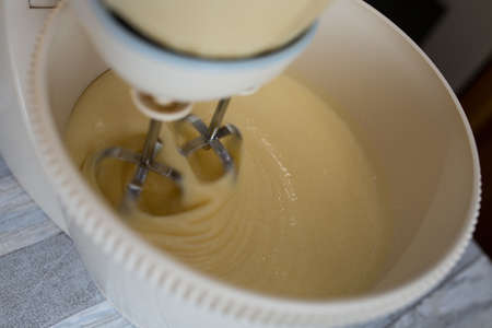 Step by step the process of making sour cream pie dough. The ingredients are added to the mixer bowl. The dough is kneaded with a whisk. Baking concept.の写真素材