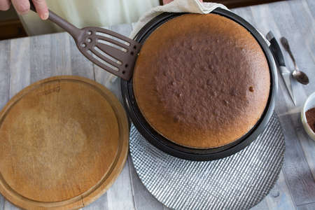 Step by step the process of making sour cream pie dough. The pie is ready. Female hands lay out the baked dough on a dish. Baking concept.の写真素材