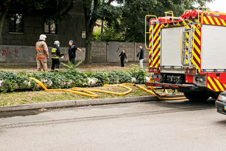 Dnepropetrovsk, Ukraine -09.20.2021: Fire on the top floor of a five-story building. Fire hoses for...