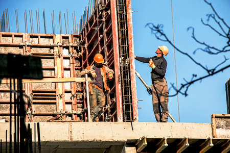 Dnepropetrovsk, Ukraine - 11.30.2021: Workers are assembling metal formwork during the construction of a residential building.のeditorial素材