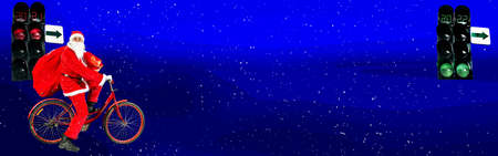 New Year's collage. Santa Clauses on a bicycle with bag of gifts on a snowy road. Ahead is a green traffic light with the numbers 2022.の写真素材