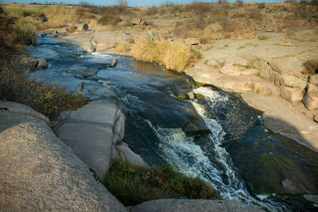 The murmuring waters of the Tokovsky waterfall in Ukraine. This is the only steppe waterfall in the...