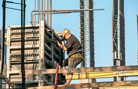 Dnepropetrovsk, Ukraine - 10.30.2021: Construction of a high-rise building. Workers prepare formwork for pouring concrete.のeditorial素材