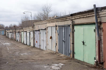 Old rusty multi-colored garages with bad roads. garage cooperative.の写真素材