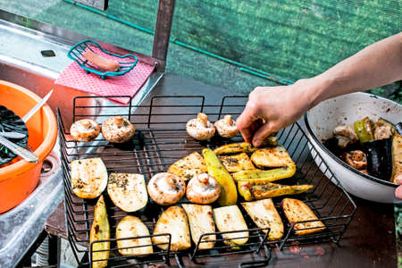 Grilled vegetables. Grill on a picnic. Food on an open fire. Zucchini, eggplant and mushrooms. Vegetarian dish. healthy eating. Fresh vegetables on the wire rack. Delicious and healthy food.の写真素材