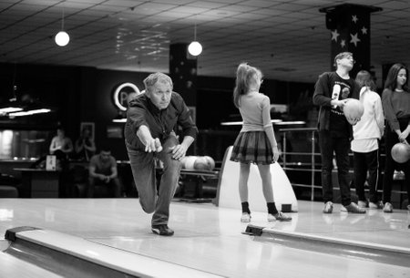 Dnipro, Ukraine - 01.13.2019: A group of young men celebrate a birthday in a bowling club.のeditorial素材