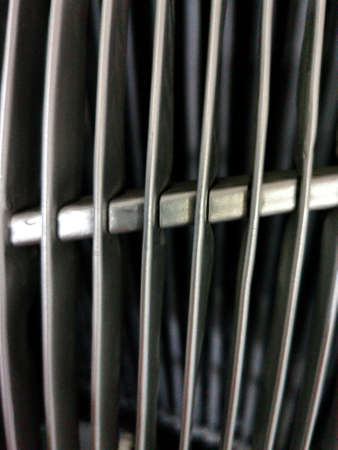 grid of car. Radiator grille. Metal close-up texture background. Chrome grill of big powerful engine...