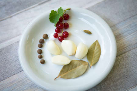 The process of making redcurrant sauce. Currant berries and spices are prepared in glass bowls.の写真素材