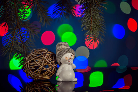 Happy snowman toy sparkling and fabulous bokeh background with copy space. Christmas background for postcards. Christmas decoration concept.の写真素材