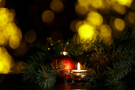 Christmas burning candle, sparkling and fabulous background with copy space. Christmas background for postcards. Christmas decoration concept.の写真素材