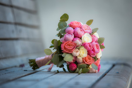 Bouquet of white and pink rose flowers on a gray wooden surface. The concept of a holiday, wedding.の写真素材