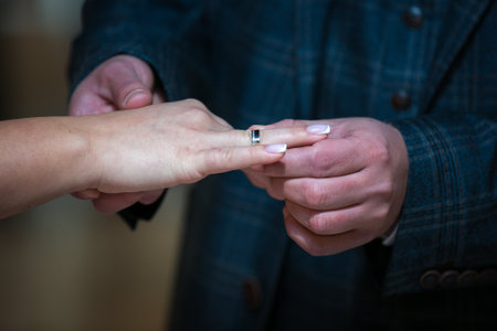The bride and groom exchange wedding rings in the church during a Christian wedding ceremonyの写真素材