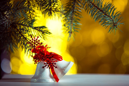 New Year's bell on sparkling and fabulous bokeh background with copy space. Christmas background for postcards. Christmas decoration concept.の写真素材