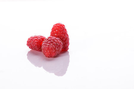 Juicy red fresh raspberries isolated on white background. Full depth of field.の写真素材