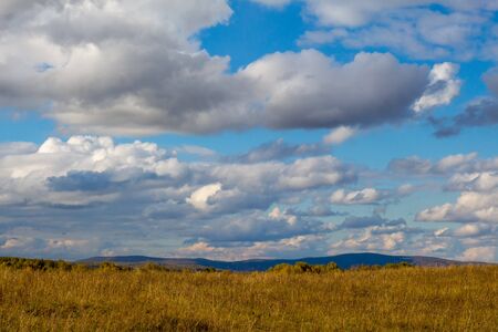 autumn clouds over the fields beautiful landscapeの写真素材