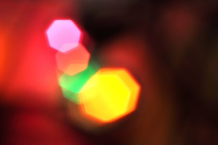 Glowing and festive colored light circles created from in camera and lens bokeh. Christmas fairy lights defocused giving a blurred effect. Background for design.の写真素材