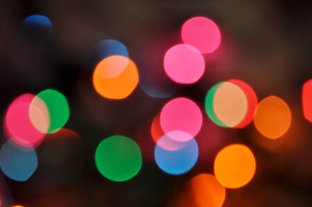 Glowing and festive colored light circles created from in camera and lens bokeh. Christmas fairy...