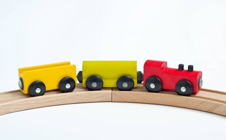 Wooden toy train with colorful blocks on a wooden railway. Educational toys.の写真素材