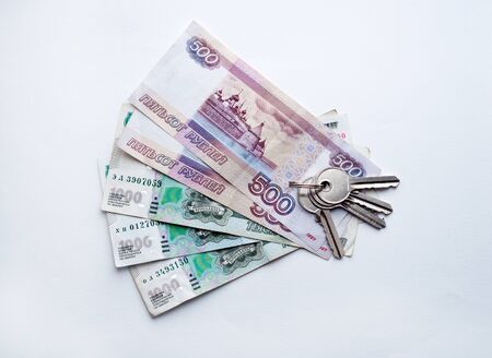 Russian rubles banknotes and house keys. The concept of buying and renting a new home.