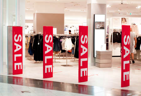 Krasnodar, Russia - August 2020, Red advertising poster at the entrance to the clothing store. Seasonal discounts in stores, clearance sale, Black Friday and shopping concept. Shopping in online stores.のeditorial素材