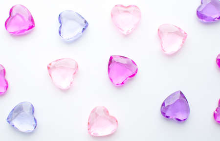 Pink and purple hearts crystals on white backgroundの写真素材