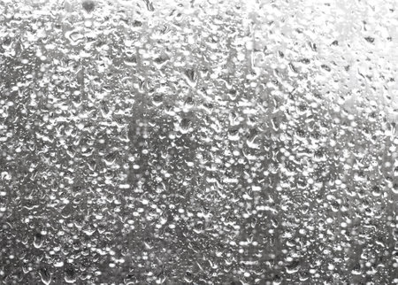 Ultimate gray background. Trendy colors inspiration. Drops on the window glass.の写真素材