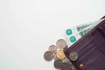 Russian rubles in the wallet on a white background. Thousand notes and various coins.Place for text.の写真素材
