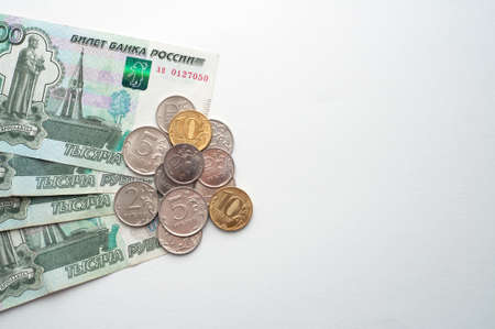 Russian rubles on a white background. Thousand notes and various coins. Place for text.の写真素材