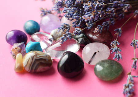 Beautiful amethyst crystals and round rose quartz stone with dry lavender bouquet. Agate, apatite, aventurine, turquoise. Magic amulets.の写真素材
