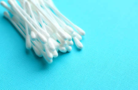 Lots of plastic cotton swabs on a blue background.の写真素材
