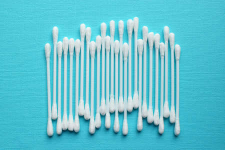 Lots of plastic cotton swabs on a blue background.の写真素材