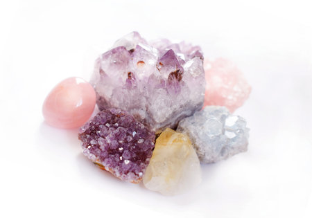 Crystals of amethyst and rose quartz. Gems on a white background. Magic stones.の写真素材