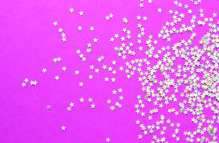 Background of shiny little stars on a bright pink background. Christmas concept. Glitter texture.の写真素材