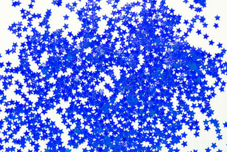 Blurred background of blue small stars on a white background. Selective focus. Christmas concept.の写真素材