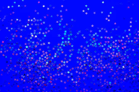 Background from shining little stars on a blue background. Selective focus. Christmas concept....