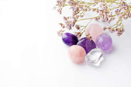 Beautiful amethyst crystals and round rose quartz stone with dry lavender bouquet. Magic amulets. Copy spaceの写真素材
