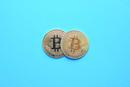 Two metal bitcoin coins on blue background. Bitcoin BTC Cryptocurrency Coins. Stock Market Concept.の写真素材
