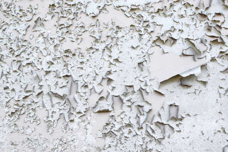 Old gray paint peeling from wall texture background. Cracked paint on metallic background. grunge...