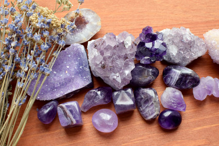 Beautiful amethyst stones and amethyst druze with dry lavender bouquet on wooden background. Magic amulets.の写真素材