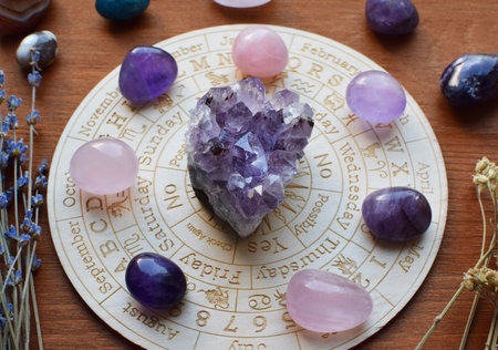 Gemstones for zodiac signs, amethysts and rose quartz on the zodiac chart. Predictions, witchcraft, spiritual esoteric practice.の写真素材