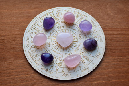 Gemstones for zodiac signs, amethysts and rose quartz on the zodiac chart. Predictions, witchcraft, spiritual esoteric practice.の写真素材