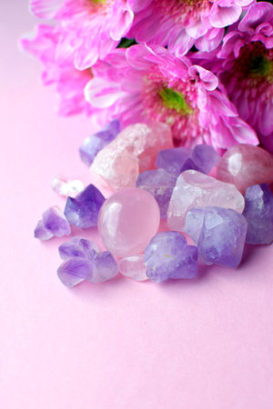 Beautiful amethyst purple crystals with pink chrysanthemum flowers. Magic amulets.の写真素材