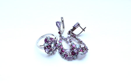 Beautiful silver earrings and ring with natural semi-precious stones: garnets - rhodolite, amethyst and topaz.の写真素材