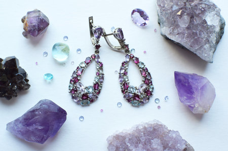 Silver jewelry with natural stones and rose quartz and amethyst stones on a white background.の写真素材