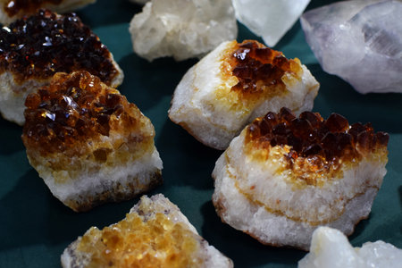 Beautiful citrine crystal cluster at a stone fair. Natural citrine druse at a stone fairの写真素材