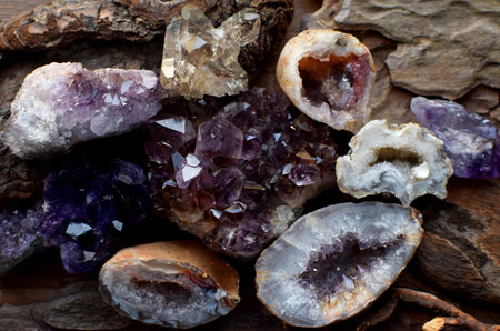 Precious amethyst crystals on wooden background, healing crystals. Beautiful violet quartz druse and...