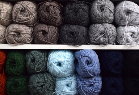 Shop shelves with multicolored skeins of yarn for knitting. Yarn for knitting for needlework. Bright multicolored threads.の写真素材